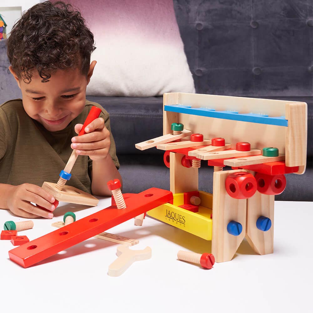 Child using wooden screwdriver 