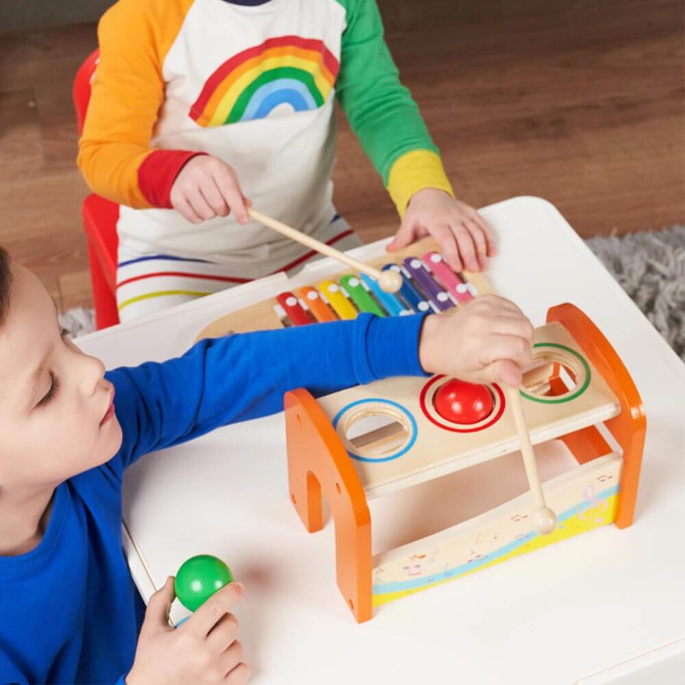 Children playing with musical bench and xylophone [lifestyle]