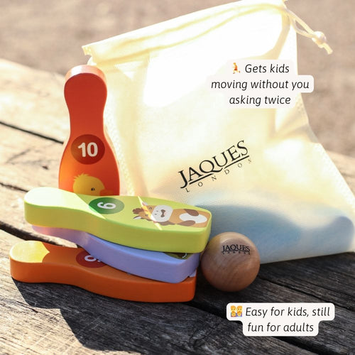 Colourful wooden toys with a Jaques of London drawstring bag on a wooden surface. 