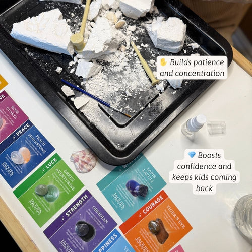 Children's play area with rocks, tools, and educational cards on a table. 