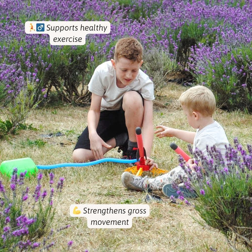 Two children playing with a toy in a field of lavender. 
