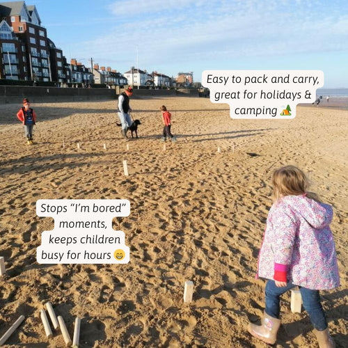 Children playing with wooden sticks on a beach with text overlay. 