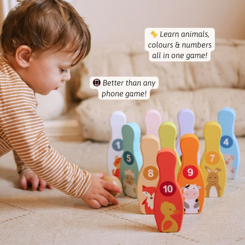Child playing with a colorful toy set on a carpeted floor. 