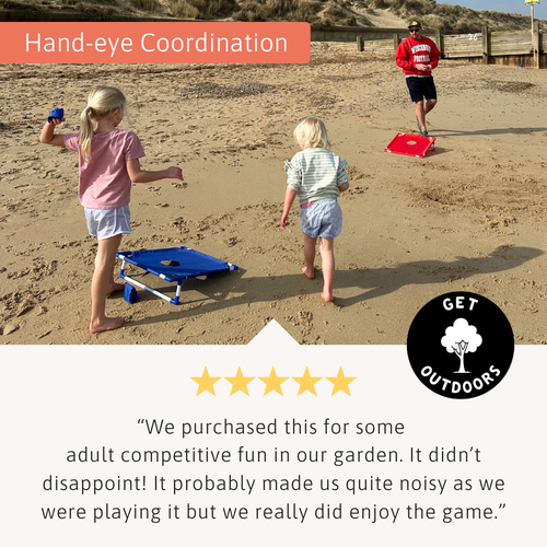 Children and an adult playing cornhole on a sandy beach with blue and red boards, shown above a five-star customer review. 