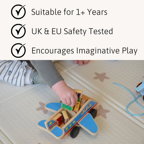 Wooden toy airplane with child's hand reaching for it on a floor, safety and suitability text above. 