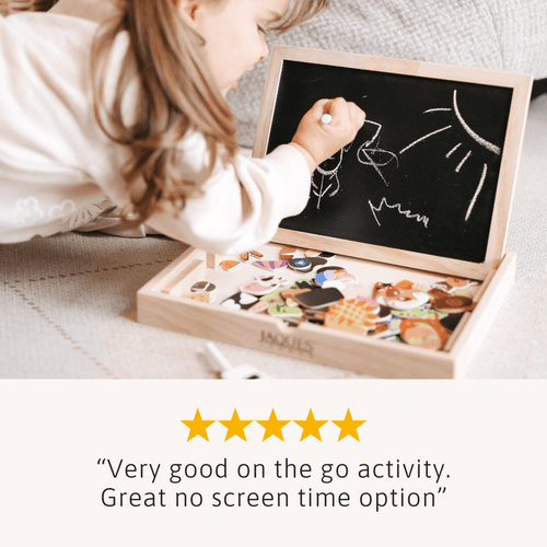 Child playing with a wooden toy that has a blackboard and colourful illustrations. 
