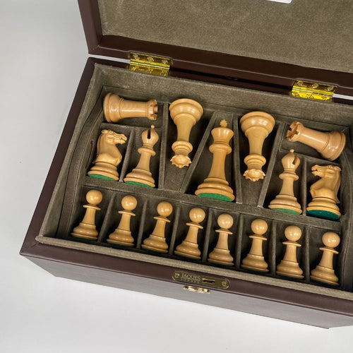 Wooden chess set with pieces in a box on a white background 