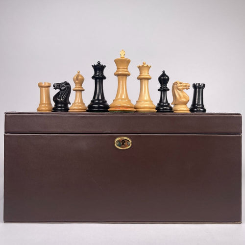 Chess pieces with a brown storage box on a light grey background 