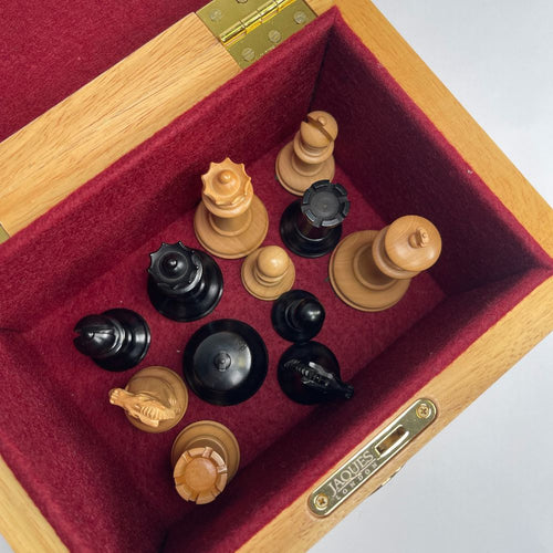 Chess pieces in a wooden box with red interior 