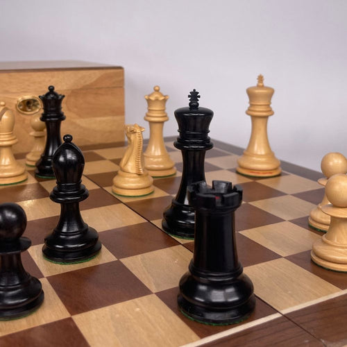 Staunton Chess Pieces in play. Oak Box in background  