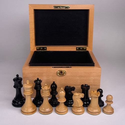Traditional Staunton Chess Pieces in front of an open Beech box with black lining. 