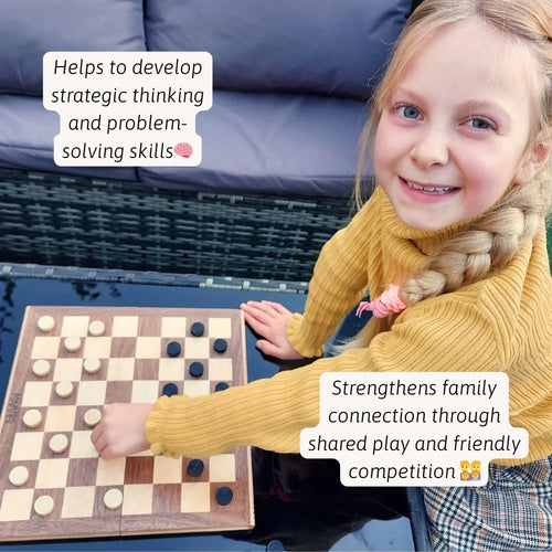 A young girl smiling while learning to play chess on a wooden chess board. 