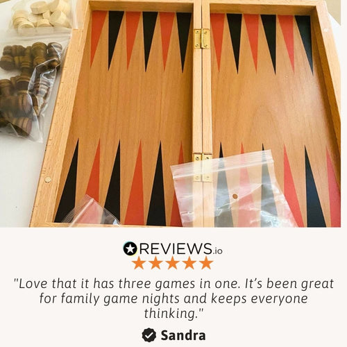 A close-up of the wooden backgammon board with game pieces placed on the triangular points. 