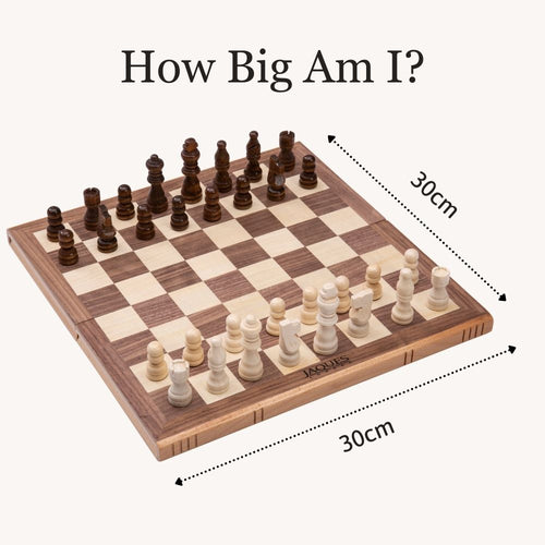 The folding chess set displayed open with all included chess and draughts pieces laid out. 