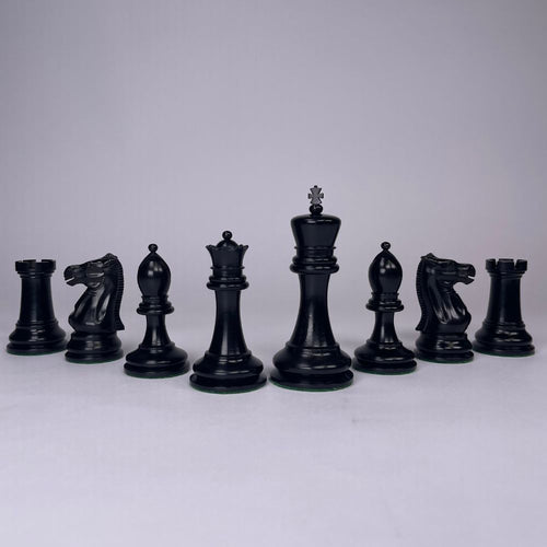 Set of black chess pieces on a light gray background 