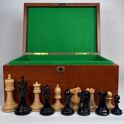 Wooden chess set with pieces and a green felt interior on a white background 