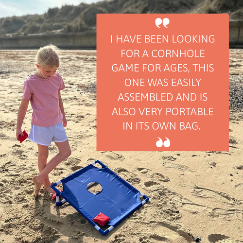 Child standing next to a blue cornhole board on the beach beside a large boxed customer quote praising the product’s easy assembly and portability. 
