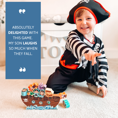 Child in pirate costume playing with toy pirate ship on carpeted floor 