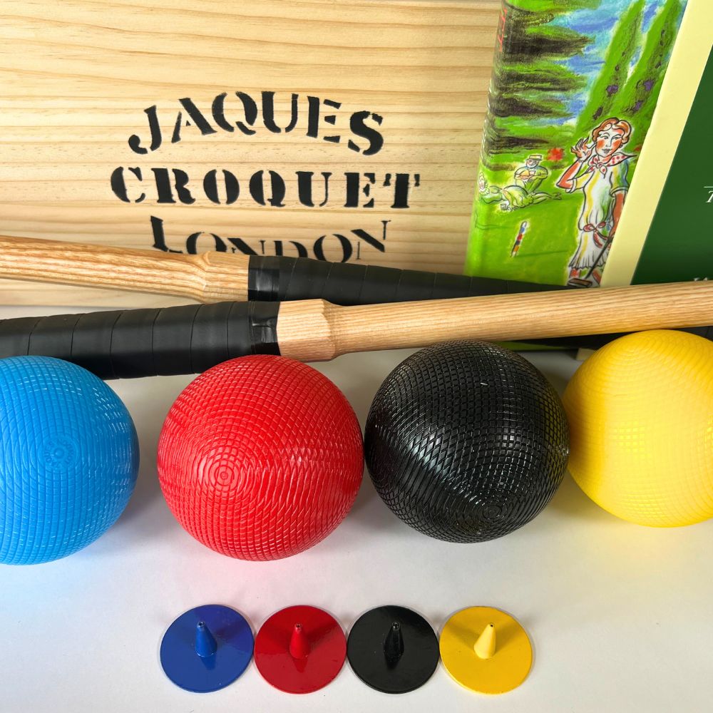 Croquet set with wooden mallet, balls, and markers on a white surface, featuring 'Jaques Croquet London' branding. 