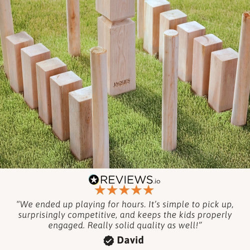 Wooden Kubb lawn game set arranged on grass ready to play 