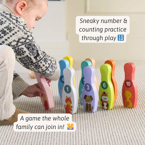 Child playing with a colorful number sorting toy on a carpeted floor. 