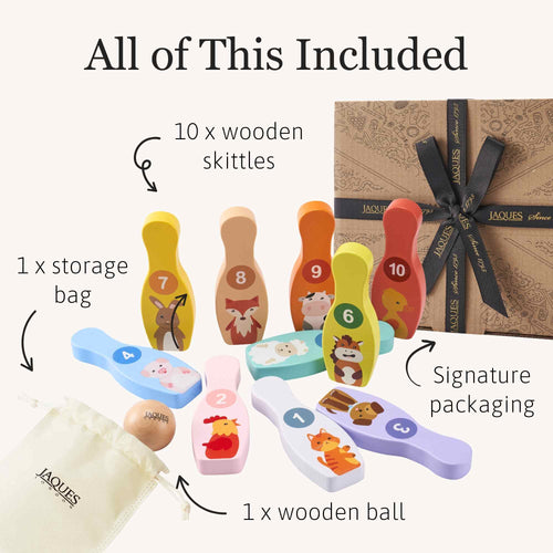 Set of wooden skittles with packaging and accessories on a white background 
