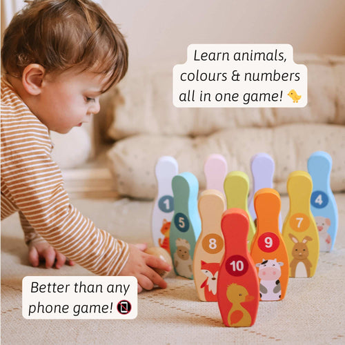 Child playing with educational toy that teaches animals, colors, and numbers. 