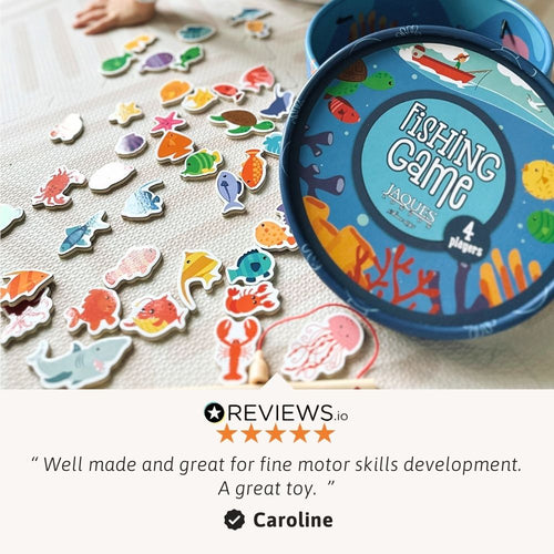 Fishing game with colourful fish pieces and a blue tin labelled 'Jacques Fishing Game' on a light surface. 