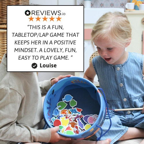 Child playing with a colourful game board held by an adult, with a five-star review displayed. 
