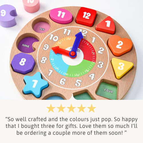 Wooden educational toy clock with colourful numbers and shapes on a white background. 
