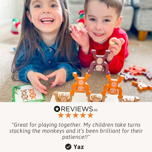 Hands-on play as a child builds a tall monkey tower 