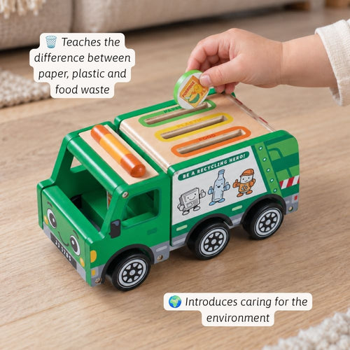 A green wooden recycling truck toy on a light wood floor, with a child's hand placing a paper disc into the slot. Text callouts describe the toy's educational benefits.