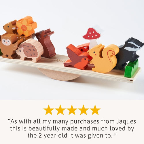 Wooden toy set with animal figures on a balance beam, featuring five-star rating text.  