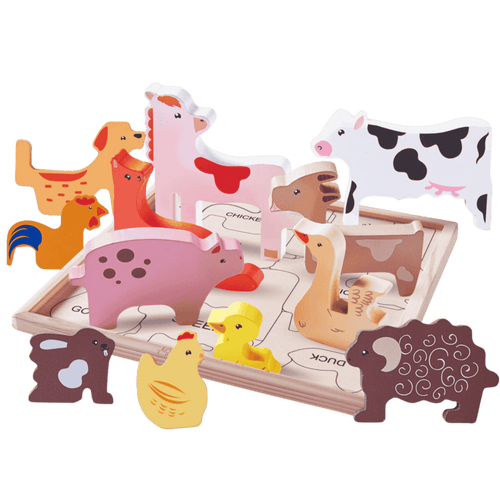 Set of wooden farm animal toys on a green background [fill]