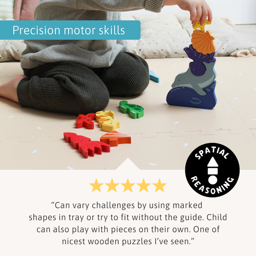 Child stacking wooden ocean animal pieces into a tall tower while sitting on the floor, with a “Precision motor skills” label and a review beneath 