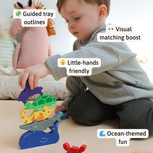 Child stacking vibrant wooden sea creatures, with callout labels for guided tray outlines, visual matching, little-hands friendly pieces, and ocean-themed fun 