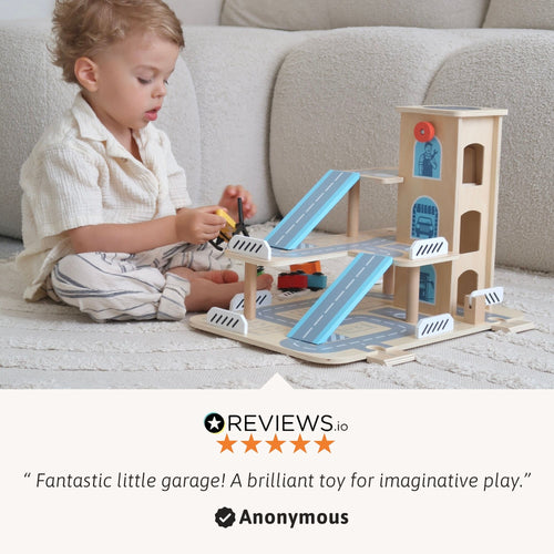 Toddler playing with a wooden parking garage toy featuring multiple ramps, cars, and a helicopter. 