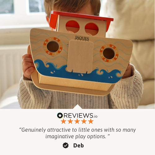 Front view of a child holding the wooden Noah’s Ark toy up to their face, with a customer review quote shown at the bottom 