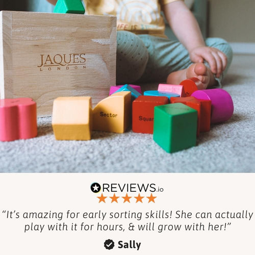 Close up of wooden shape sorting cube with colourful blocks 