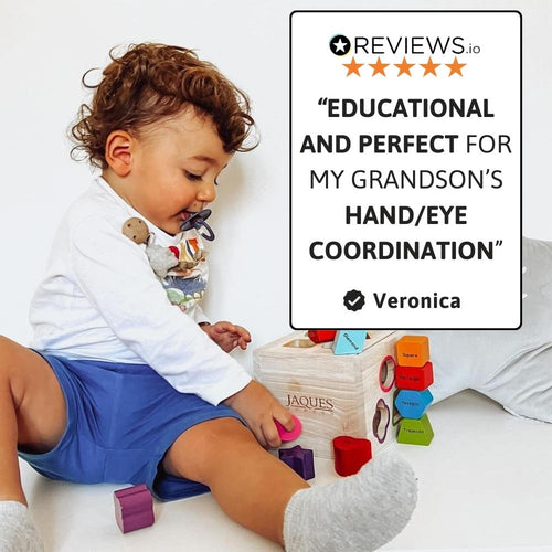 Toddler playing with wooden shape sorter to develop coordination 