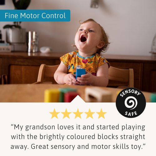Smiling toddler sitting at a table playing with brightly coloured sensory blocks, with a fine motor control label and customer review 