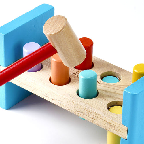 Colourful wooden hammering bench with pegs in play 