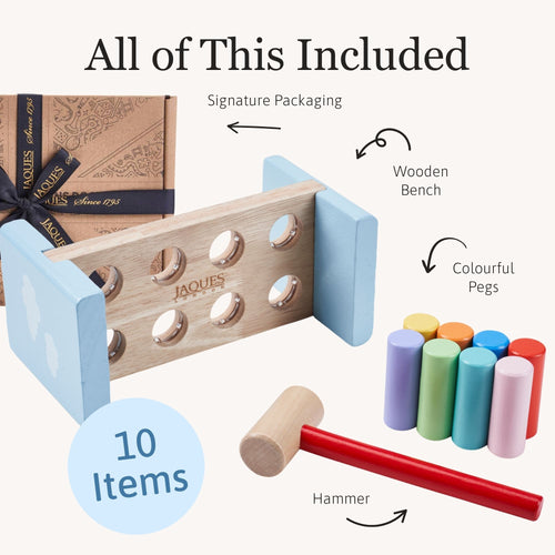 Wooden game set with packaging, wooden bench, colourful pegs, and hammer on a white background.