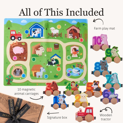 A children's wooden farm-themed toy set shown on a light beige background with text reading 'All of This Included.' The set includes a colorful farm play mat, multiple wooden animal and tractor figures with number wheels, magnetic animal carriages, a signature box, and a wrapped package.