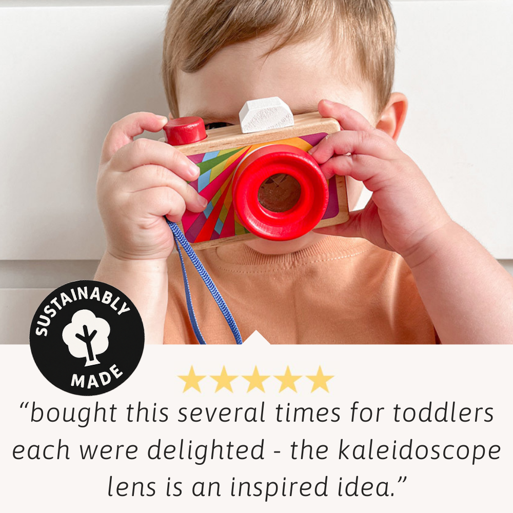 Child playing with a colourful toy camera, with a sustainability label and customer review text.
