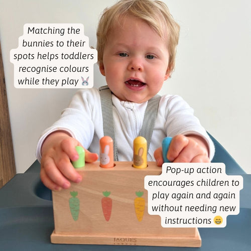 A toddler pressing the pop-up bunnies and discovering the fun surprise action 