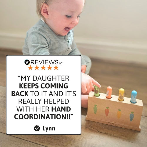 A happy toddler enjoying interactive pop-up play 