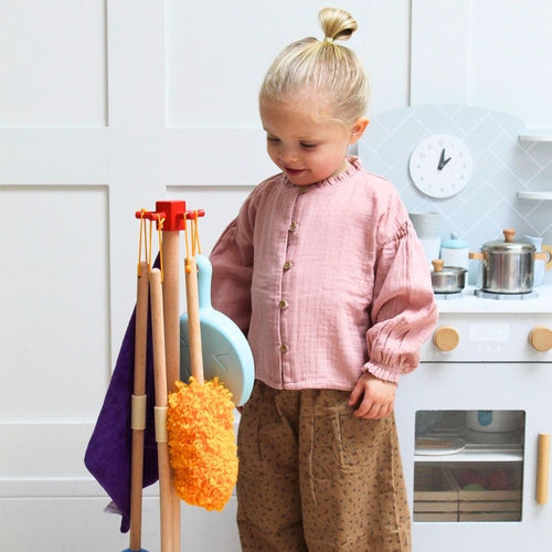  Girl smiling standing next to the clean and playset 