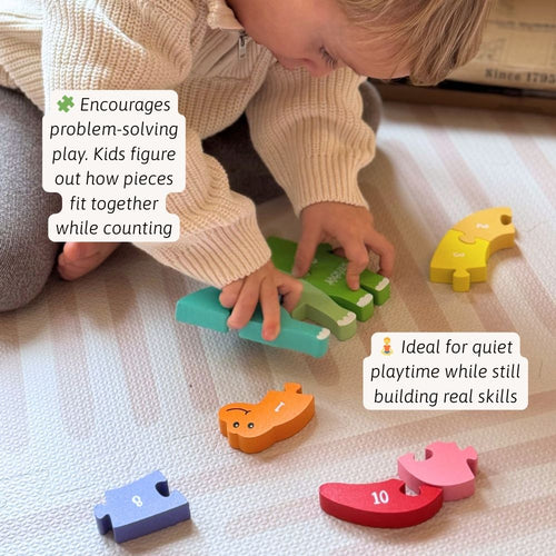 Child playing with colourful wooden puzzle pieces on a light surface. 