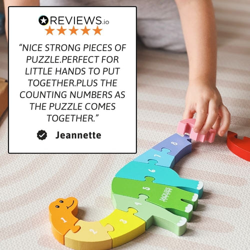 Children's dinosaur puzzle with colourful pieces and a child's hand interacting with it, on a soft surface.. 